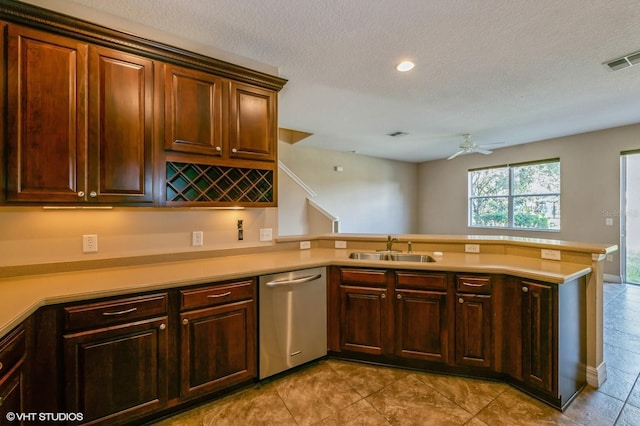 kitchen with kitchen peninsula, stainless steel dishwasher, a textured ceiling, ceiling fan, and sink