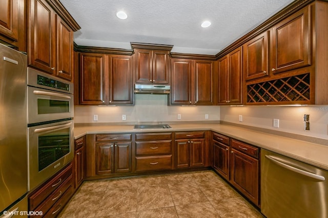 kitchen featuring a textured ceiling and appliances with stainless steel finishes