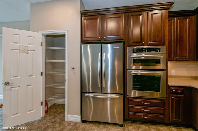 kitchen featuring dark brown cabinets and stainless steel appliances