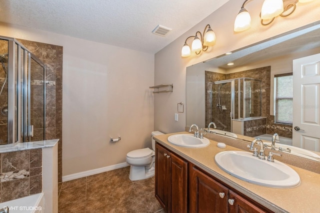 full bathroom with vanity, shower with separate bathtub, a textured ceiling, and toilet