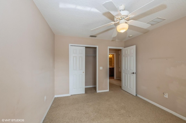 unfurnished bedroom with light carpet, a closet, and ceiling fan