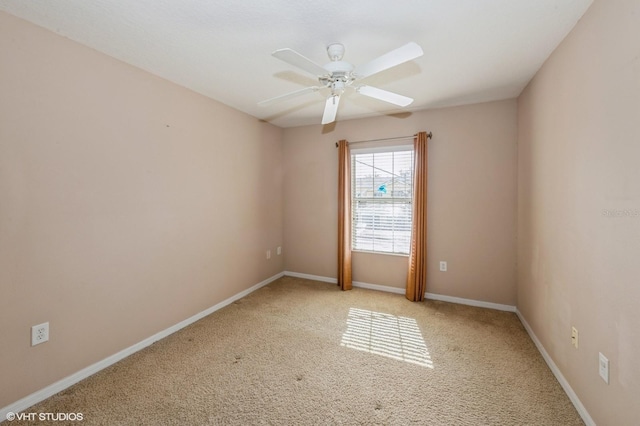 carpeted spare room featuring ceiling fan