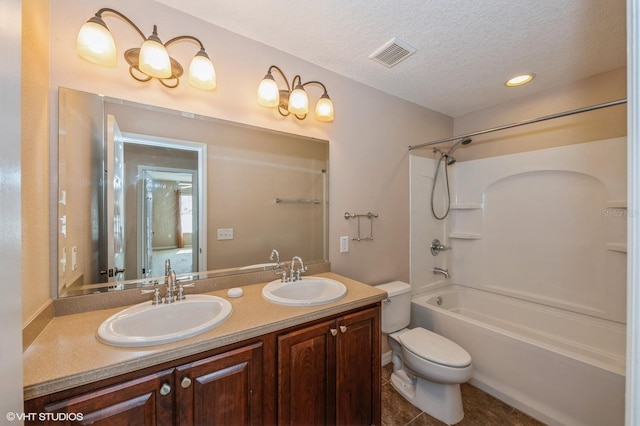 full bathroom with shower / bath combination, tile patterned floors, vanity, a textured ceiling, and toilet