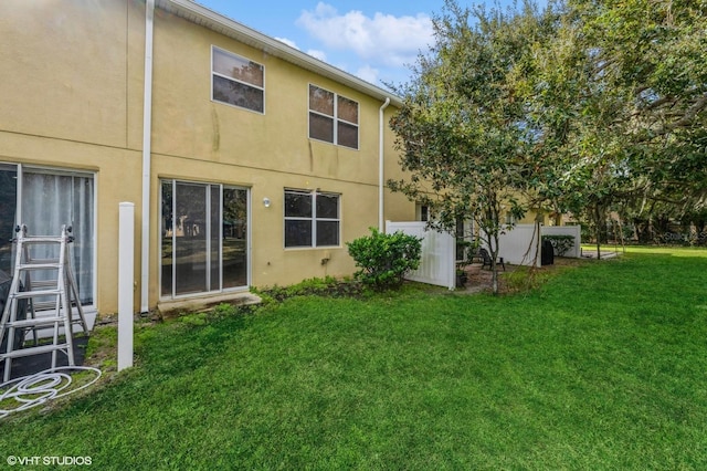 rear view of property with a lawn