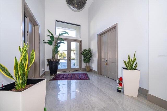 foyer entrance featuring a high ceiling and french doors