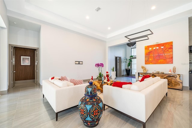 living room with a tray ceiling