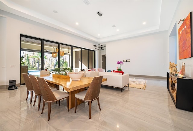 dining room with a tray ceiling