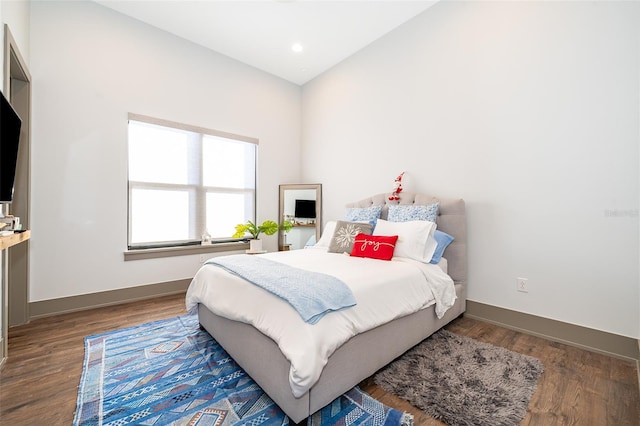 bedroom featuring vaulted ceiling and dark wood-type flooring