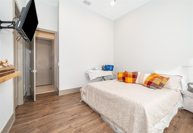 bedroom with dark hardwood / wood-style floors