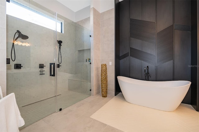 bathroom featuring tile patterned flooring and separate shower and tub