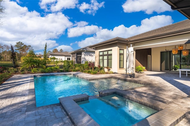 view of swimming pool featuring an in ground hot tub and a patio