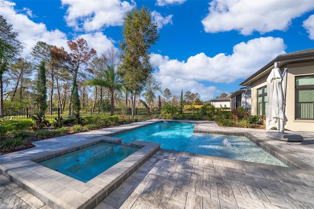 view of swimming pool featuring an in ground hot tub