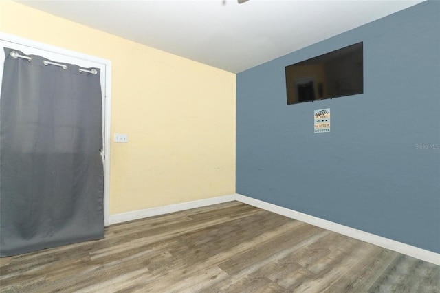 spare room featuring wood-type flooring