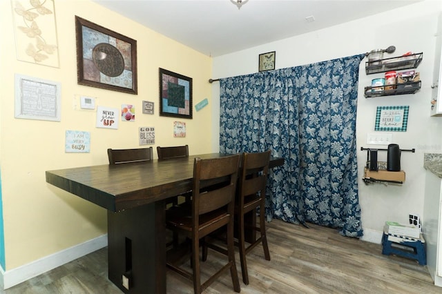 dining space with dark hardwood / wood-style floors