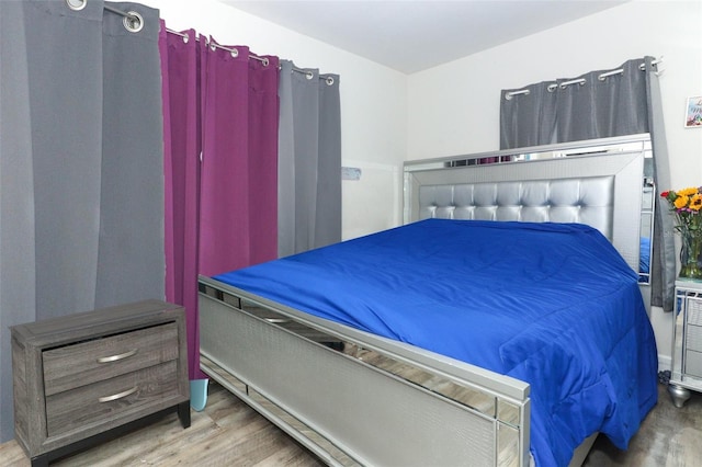 bedroom with wood-type flooring