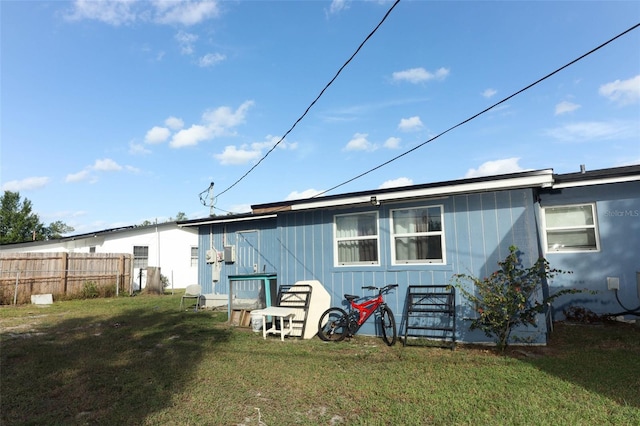 rear view of house featuring a yard