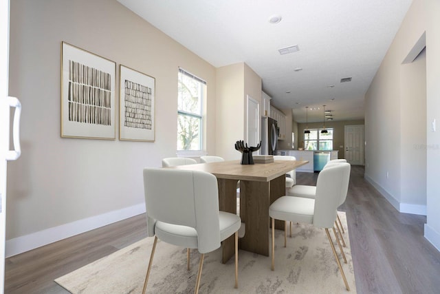 dining area with wood-type flooring