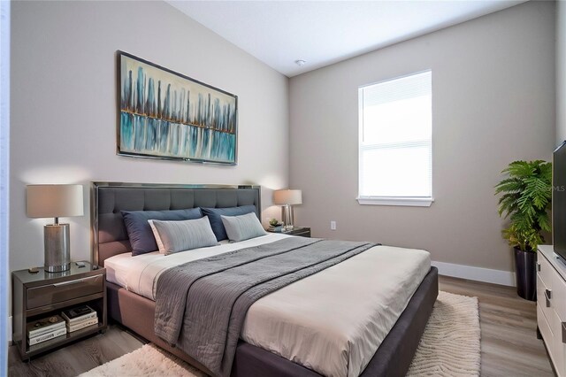 bedroom with hardwood / wood-style floors