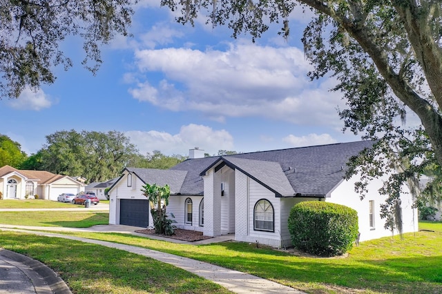 view of front of property with a front lawn and a garage