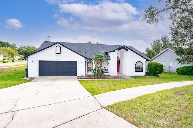 view of front facade featuring a front yard and a garage