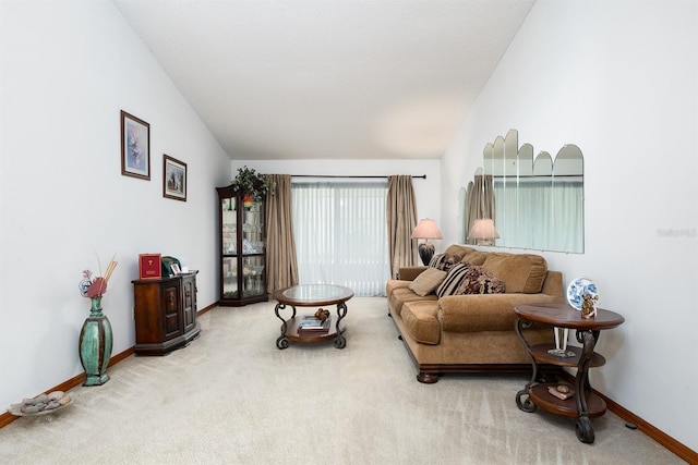 living room featuring carpet floors and lofted ceiling