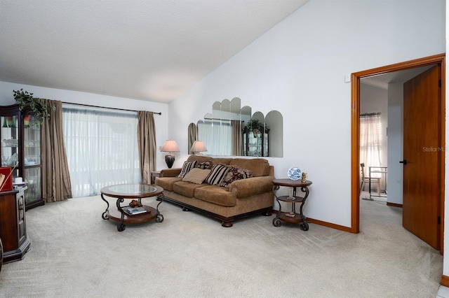 carpeted living room featuring a textured ceiling