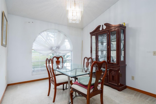 carpeted dining space featuring vaulted ceiling, a chandelier, and a textured ceiling