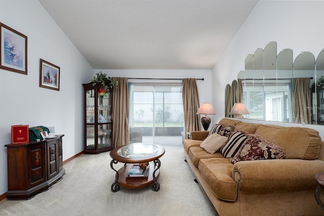 carpeted living room featuring vaulted ceiling