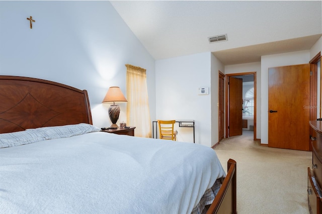 carpeted bedroom featuring lofted ceiling