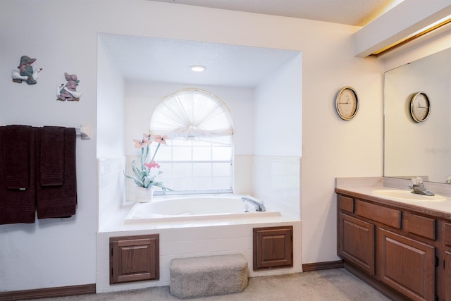 bathroom with vanity and a relaxing tiled tub