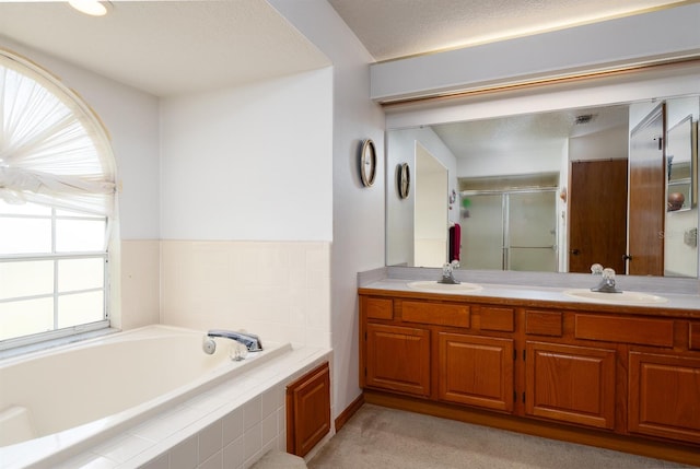 bathroom featuring vanity and shower with separate bathtub