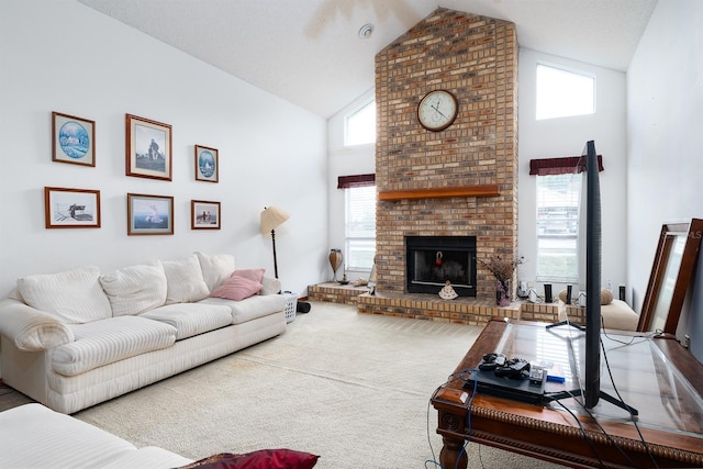 carpeted living room featuring a fireplace, a textured ceiling, high vaulted ceiling, and plenty of natural light