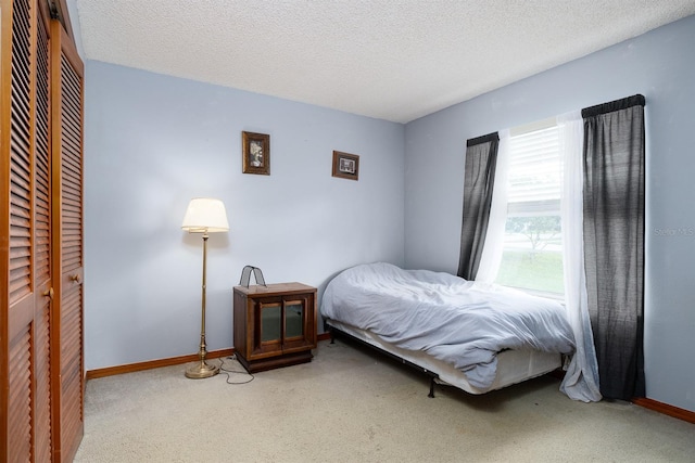 bedroom featuring carpet and a textured ceiling