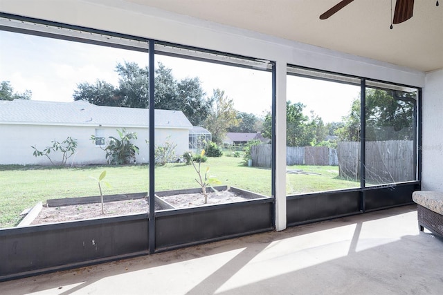 sunroom featuring ceiling fan