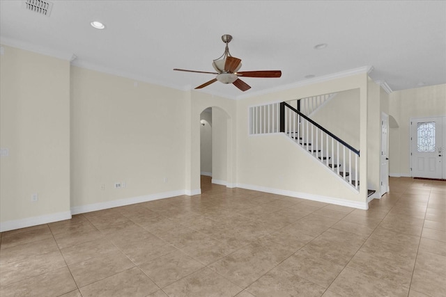 19206 Robertson St, Orlando, FL 32833 - unfurnished living room with arched walkways, stairway, ceiling fan, light tile patterned flooring, and ornamental molding