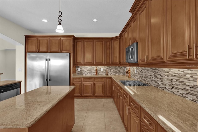 19206 Robertson St, Orlando, FL 32833 - kitchen featuring appliances with stainless steel finishes, brown cabinets, light stone countertops, pendant lighting, and tasteful backsplash