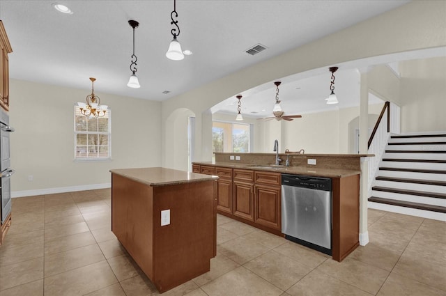 19206 Robertson St, Orlando, FL 32833 - kitchen featuring stainless steel dishwasher, an island with sink, arched walkways, brown cabinets, and pendant lighting