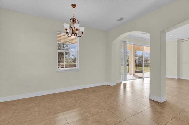 tiled spare room with crown molding and a notable chandelier