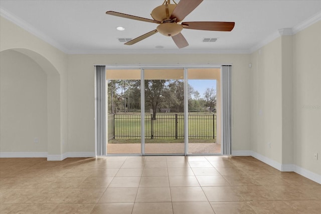 19206 Robertson St, Orlando, FL 32833 - empty room featuring healthy amount of natural light, crown molding, arched walkways, a ceiling fan, and tile patterned floors