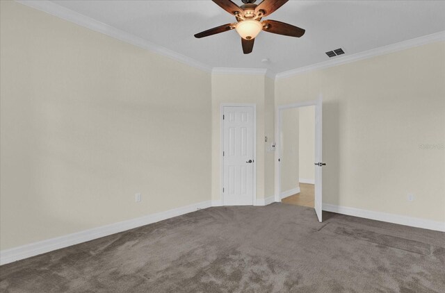 carpeted empty room with ceiling fan and ornamental molding