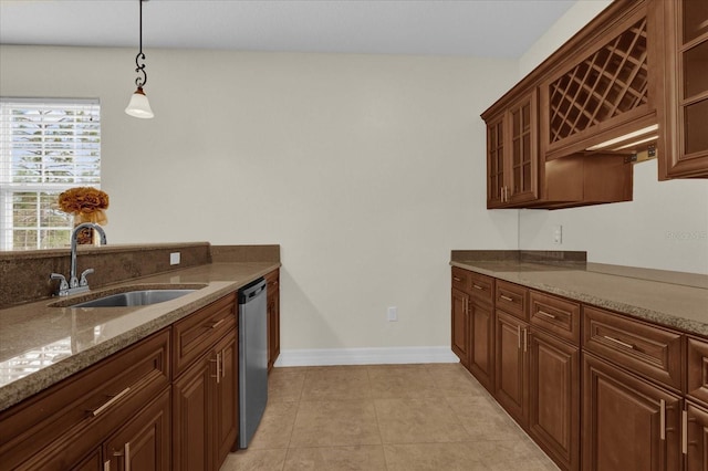 19206 Robertson St, Orlando, FL 32833 - kitchen featuring dishwasher, hanging light fixtures, light tile patterned floors, light stone countertops, and glass insert cabinets