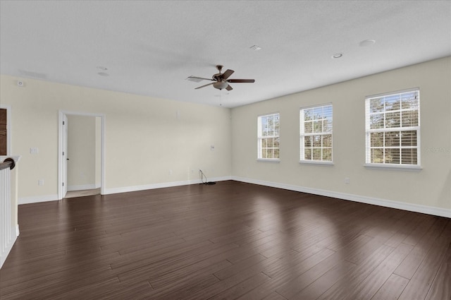 spare room with a textured ceiling, dark hardwood / wood-style flooring, and ceiling fan