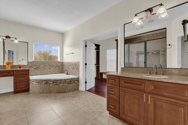 19206 Robertson St, Orlando, FL 32833 - full bathroom featuring a garden tub, vanity, a stall shower, and tile patterned flooring