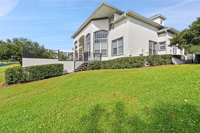 view of side of home with a yard