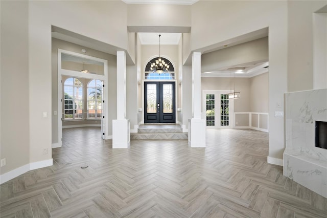 entryway with french doors, light parquet floors, and a healthy amount of sunlight