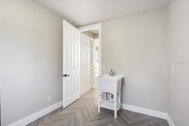 laundry area with light parquet floors