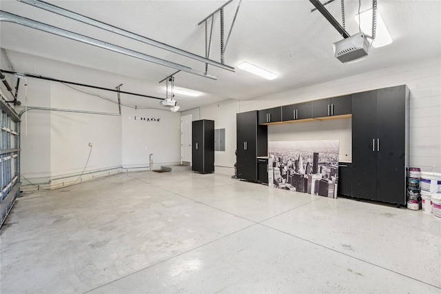 garage featuring electric panel and a garage door opener