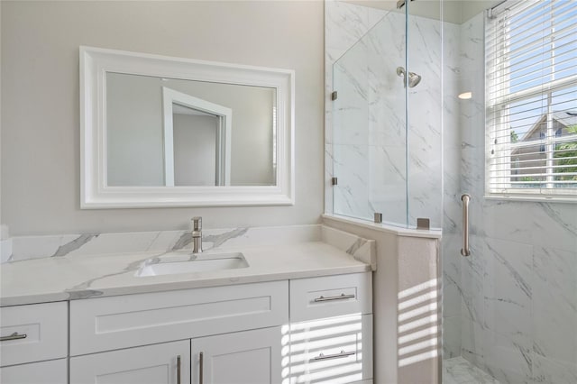 bathroom featuring vanity and a shower with shower door