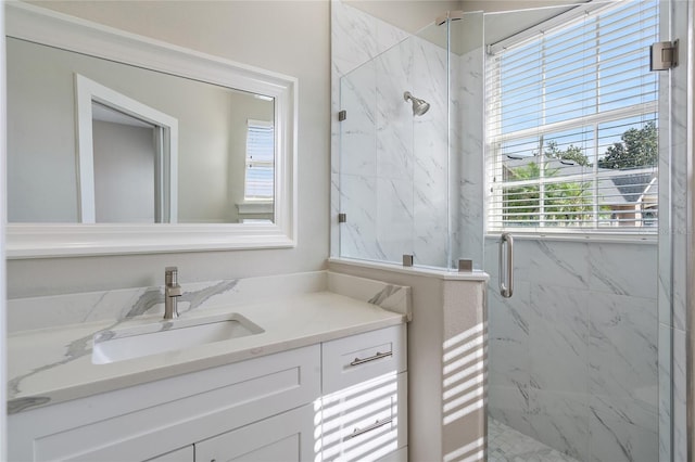 bathroom featuring vanity and an enclosed shower