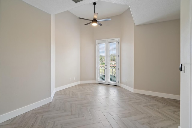 spare room featuring french doors, a textured ceiling, ceiling fan, and light parquet flooring